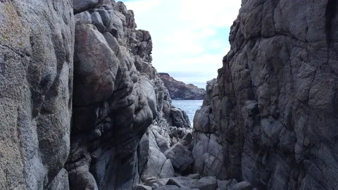 Drone Fly through of rock stacks on the ocean Video stock 217824333