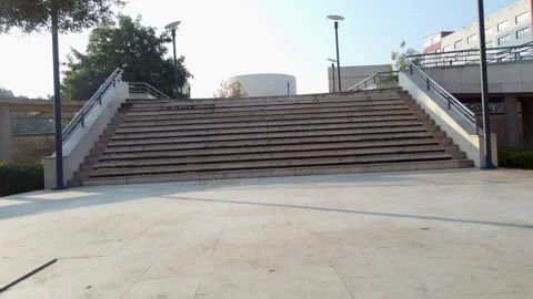 Drone fly-through under a large tree and up modern urban stairs. Stock Footage 329333109