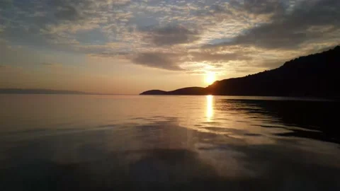 Drone fly very closely over sea towards sunset Stock Footage 144921373