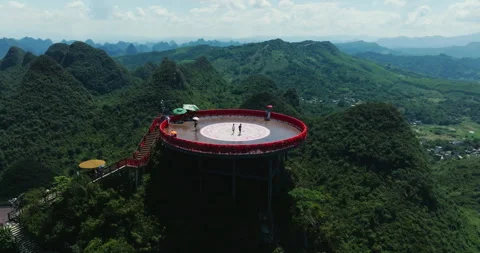 Drone flyaway of Ruyi cloud top platform surrounded by karst mountains Stock Footage 340370465