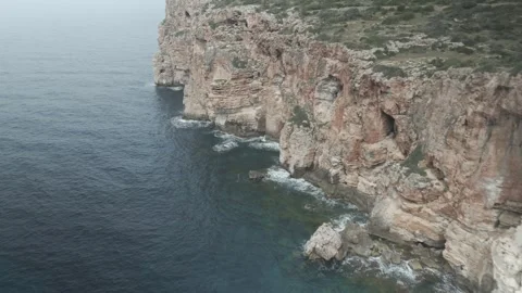 Drone Flyby Along Rocky Cliffs and Mediterranean Sea in Menorca Vídeo Stock 344190871