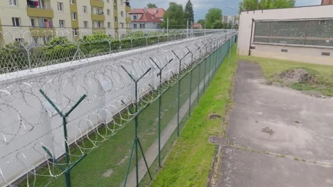 Drone Flyby of Barbed Wire Prison Fence Stock Footage 320149652