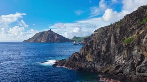 Drone flyby of cliffs and rocky landscape over the ocean Stock Footage 308517752