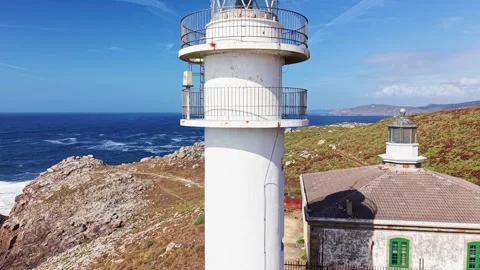 Drone flyby of Faro de Cabo Tourinan lighthouse tower on Atlantic coast Stock Footage 345161924