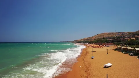 Drone flyby over a beautiful beach with rough sea with waves Stock Footage 120426010
