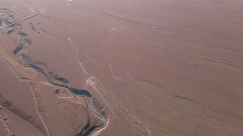 Drone flyby over dried-up riverbed in the desert Stock Footage 213156304