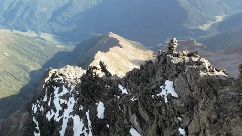 Drone flyes towards  sharp Alpine mountain ridge Video stock 325328734