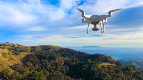 Drone Flying abobe the mountain tops blue sky green grass sun set Ojai phantom Stock Footage 100650234