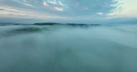 Drone flying above dense sea fog over Cliffs of Moher coastline in Ireland at Stock Footage 339507719