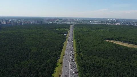Drone flying above forest highway with heavy traffic Stock Footage 321369985