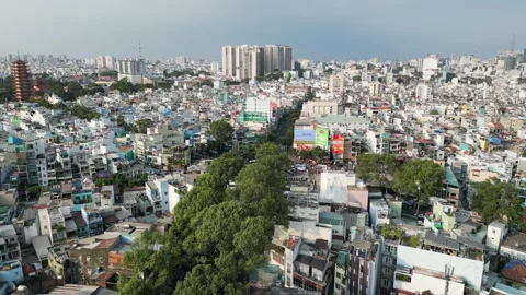 Drone Flying Above Ho Chi Minh City Rooftops and Streets in Vietnam Stock Footage 335575891