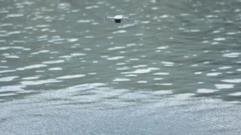 Drone flying above the lake making ripples in the water Stock Footage 276096624