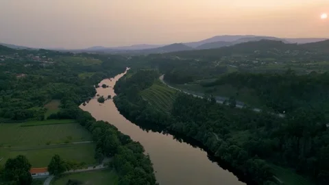 Drone flying Above Lima River and green field at Sunset in Ponte De Lima, Vidéo 262236042