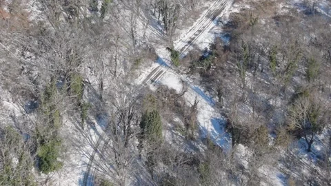 Drone flying above mountain forest with snow covered terrain Stock Footage 328282737