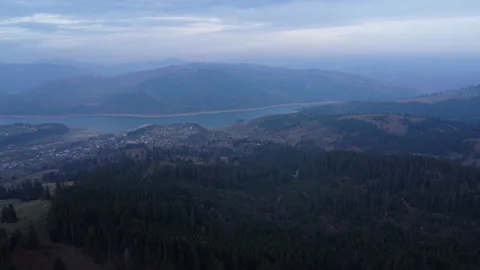 A drone flying above the mountains captures a beautiful blue lake Video stock 227392952