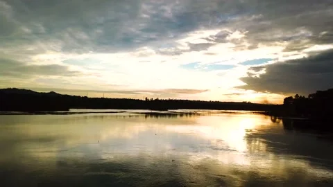 Drone flying above Nile River water level, magical reflection of sunset Video stock 196855889
