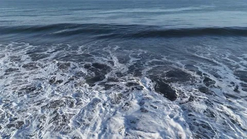 Drone flying above ocean wave in the Pacific Ocean at sunrise Video stock 339074886
