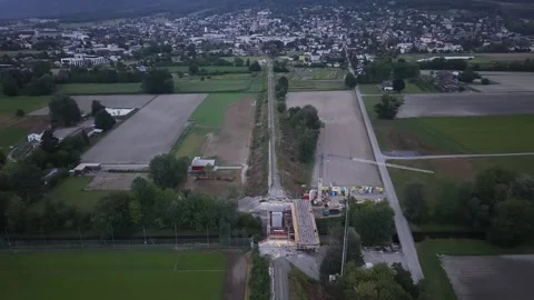 Drone flying above railway line and new bridge construction toward town Stock Footage 341801300