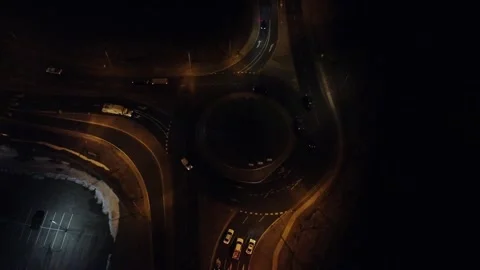 Drone flying above roundabout at night time with traffic  스톡 동영상 294723561