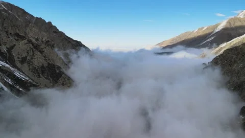 Drone Flying Above Thick Fog Filling a Mountain Valley Stock Footage 340324351