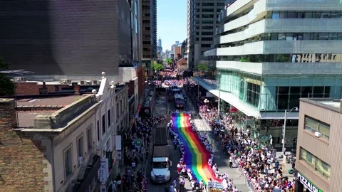Drone Flying Above Toronto Pride Parade with Massive Rainbow Flag Video stock 337912627