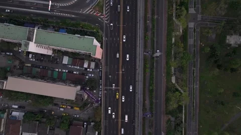 Drone flying above traffic flow on highway at sunset Bangkok Video stock 306664176