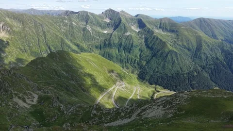 Drone flying above Transfăgărășan mountain road descending 스톡 동영상 340824982
