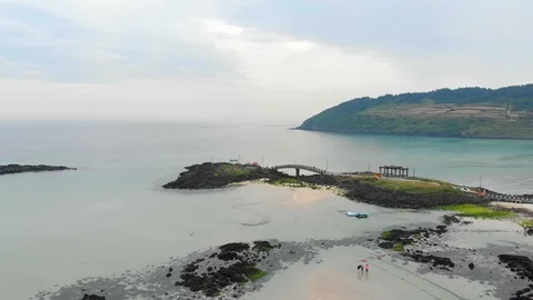 Drone flying across beach to bridge in turquoise waters Video stock 91092304