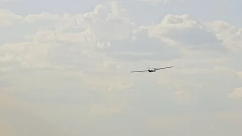 A drone is flying against the backdrop of the sky. An aircraft-shaped drone is Stock Footage 261090632