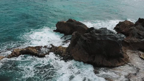 Drone flying along cliff beach. Beautiful coastline with waves. Bird view Stock Footage 169979751