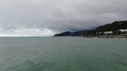 Drone flying along cloudy coastline with hills and sea, D-Log footage Stock Footage 321018021