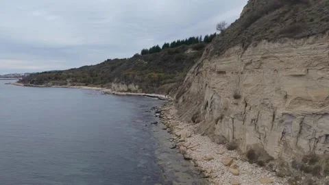 Drone Flying Along Coastal Cliffs and Rocky Shoreline in Autumn Stock Footage 320930806