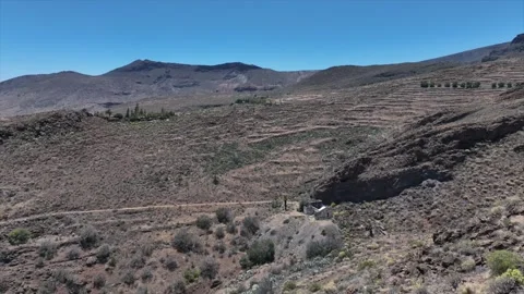 Drone Flying Along Dry Hillside Toward Abandoned House Ruins Stock Footage 310064602
