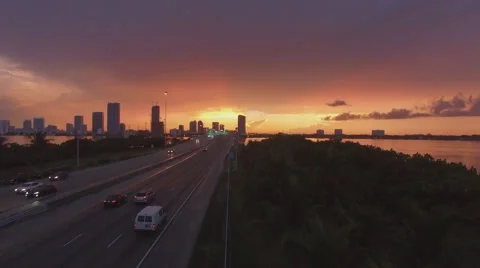 Drone Flying Along Freeway at Sunset in Miami Beach 4k Stock Footage 68928597