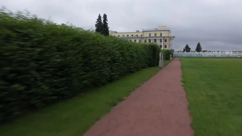 Drone flying along garden path toward palace Video stock 321896796