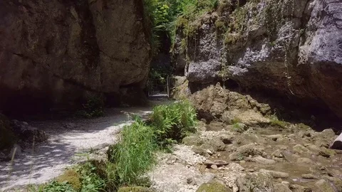 Drone flying along hiking path with creek 스톡 동영상 96732744