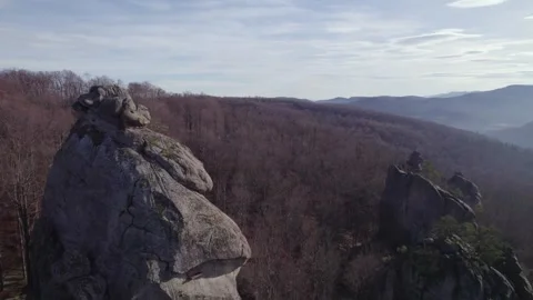 Drone flying along massive rocky cliffs above forest Stock Footage 327206493