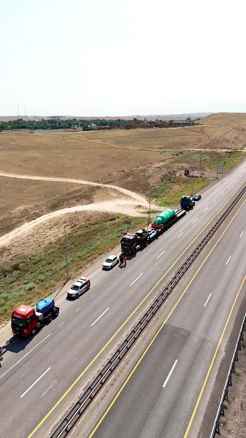 Drone Flying Along Parked Heavy Haul Convoy with Oversized Cargo 動画素材 339972876