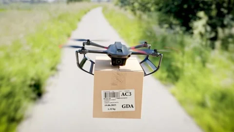 The drone is flying along the road with a package for the customer - a clos.. Stock-Footage 243003567