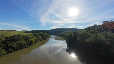 Drone Flying Along a Wide River in Rural Landscape Stock Footage 340409685