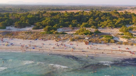 Drone flying alongside beach full of tourists Stock Footage 100265412