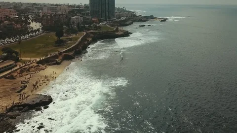 Drone flying alongside the shore of La Jolla, San Diego beautiful real estate Stockbeeldmateriaal 105930159