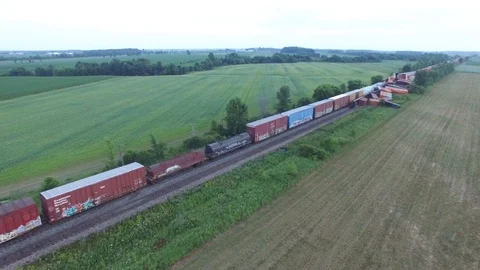 Drone flying alonside stopped train interrupted by toppled cars after crash Stock Footage 92664082
