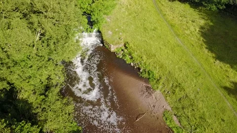Drone flying and adjusting the camera angle above a river Stock Footage 163615448