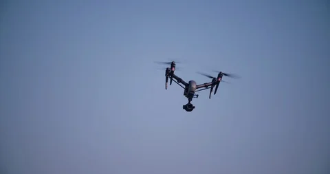 Drone flying and filming in clear blue sky Stock Footage 113704667