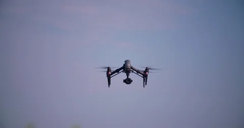 Drone flying and filming in clear blue sky Stock Footage 113705473