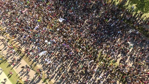 Drone flying and rising over enormous protest for the environment in city Stock Footage 116794489