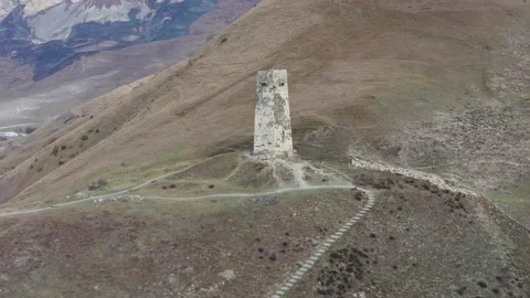 Drone flying around ancient alone tower of dead city in sunny day Video stock 165547878