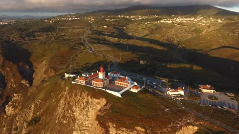 Drone flying around Cabo da Roca lighthouse located on a rocky cliff in the Stock Footage 208356809
