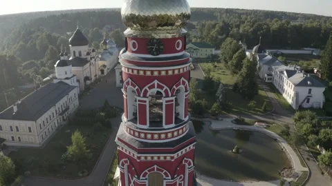 Drone flying around clock tower into monastery complex Stock Footage 328388795